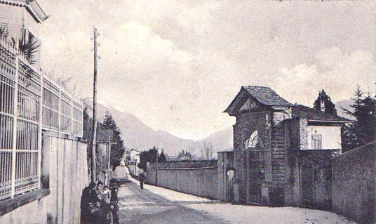 Via Regina in Gravedona on Lake Como, early 1900s in front of the entrance to Palazzo Gallio with electricity pylon